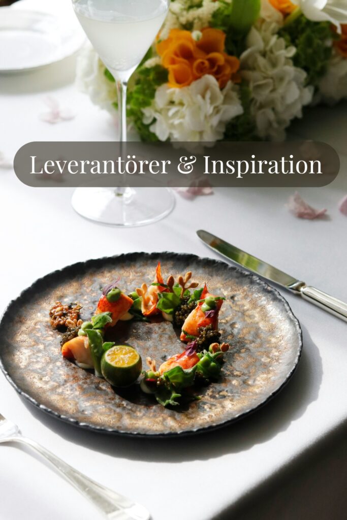 Elegant upplagd bröllopsrätt på keramiskt fat med citrus och grönt, blomsterdekoration och drink på vit duk – inspiration för bröllopsmiddag och catering.